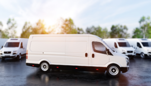 White cargo vans parked in a fleet lot.