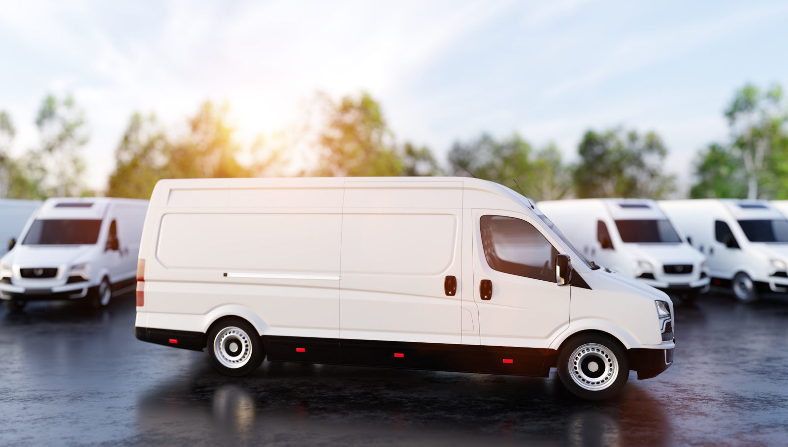 White cargo vans parked in a fleet lot.