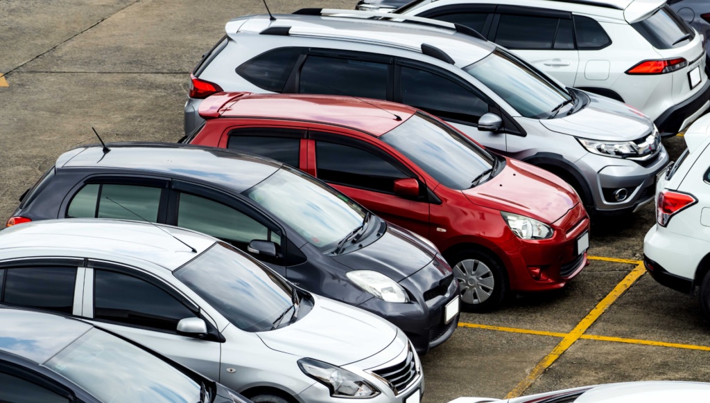 Colorful compact cars parked in a parking lot.
