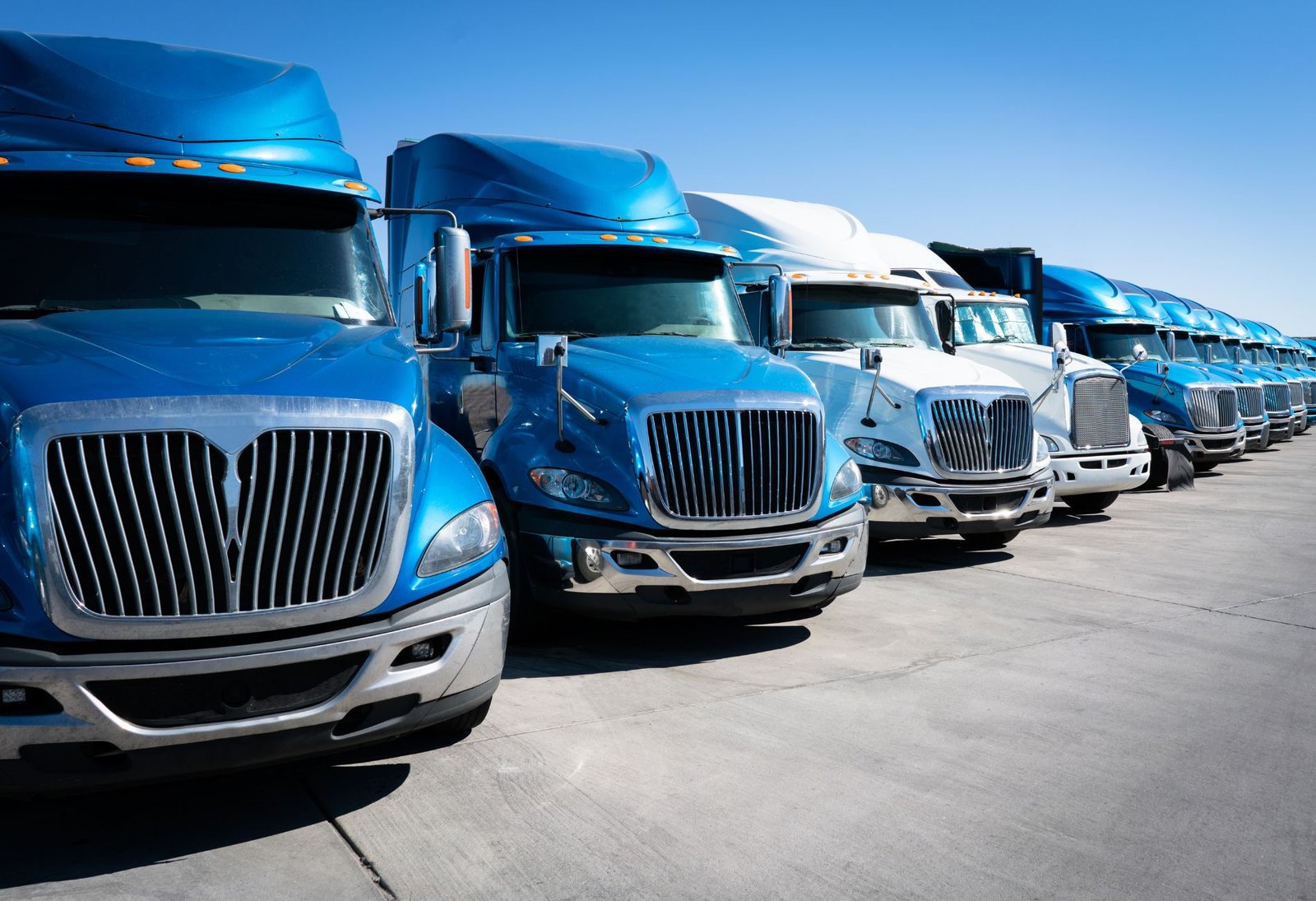 Row of semi trucks parked in fleet lot