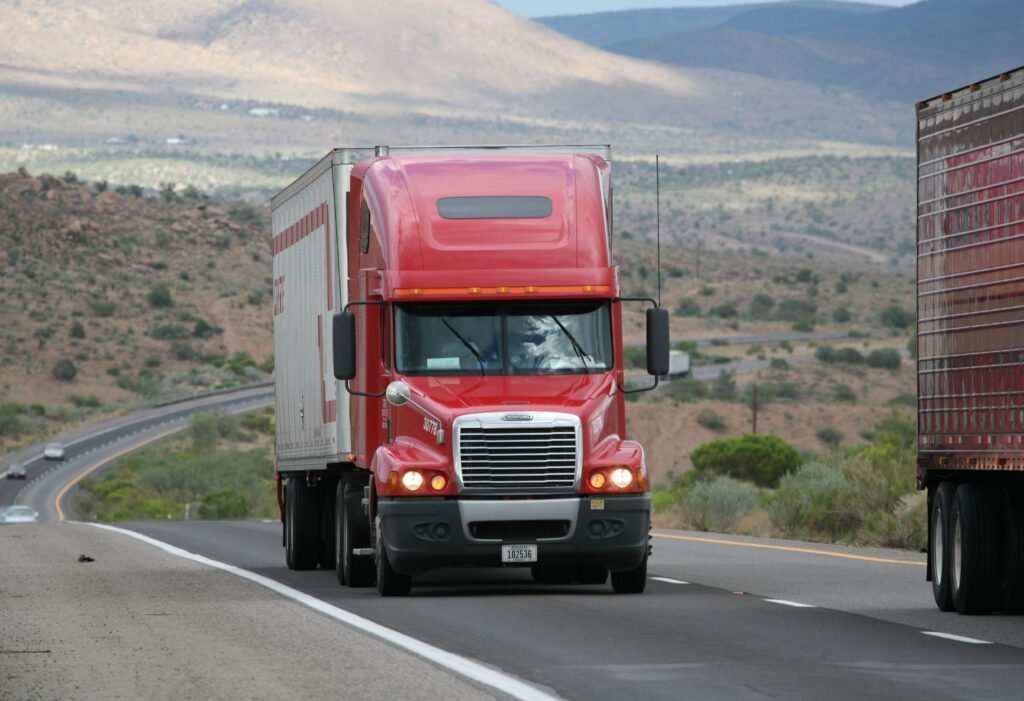 Red semi truck driving on highway