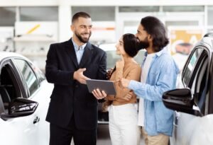 Car dealer helping customers buy a vehicle