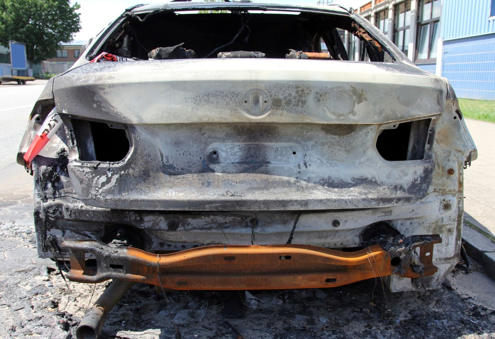 Burned car shell with rear fire damage